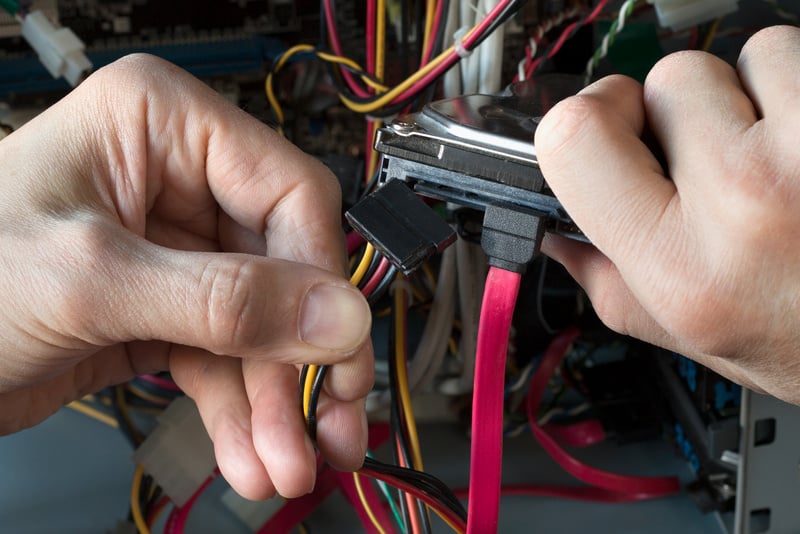 Connection HHD. A man repairs desktop PC. Technician equipment repair. Computer repair process